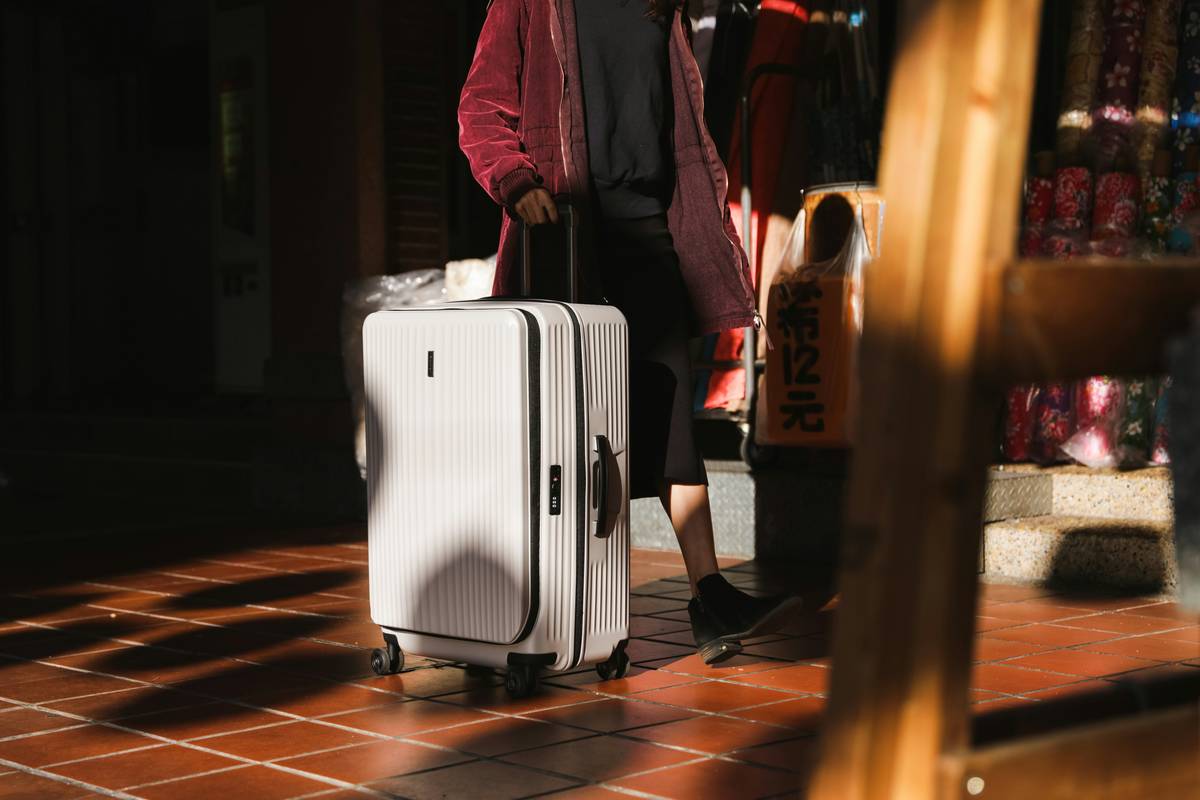 Durable Hardshell Luggage shown side-by-side with a dented competitor model after simulated airport trolley drop test